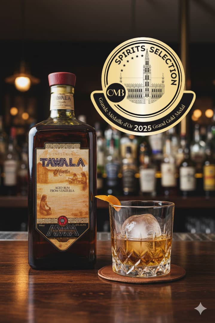 Tawala aged Venezuelan rum bottle beside a served rum on the rocks in a bar