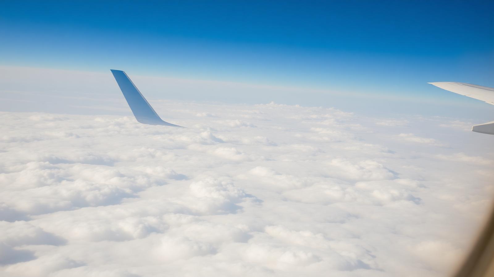 Airliner wing above the clouds on an international route
